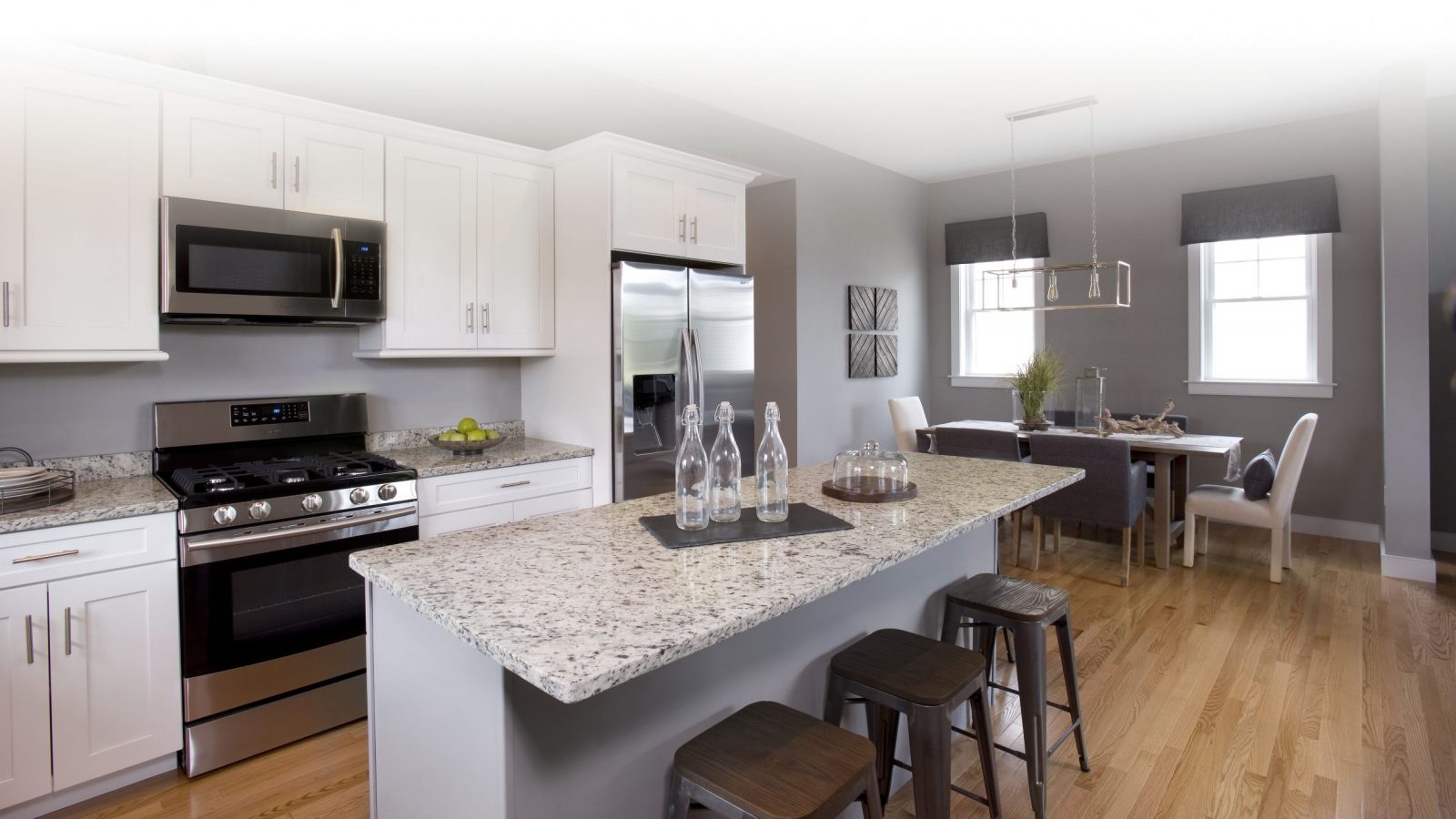 A modern and efficient kitchen layout opens to a dining room with views of conservation land from the great room windows. 
